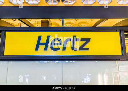 The sign of Hertz car rental company on a parking garage on 34th street ...