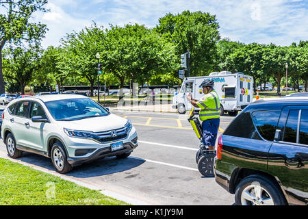 Washington DC, USA - July 3, 2017: Police traffic officer writing ticket for car illegally parked while riding segway on national mall Stock Photo