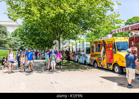 Washington DC, USA - July 3, 2017: Food trucks on street by National Mall on Independence Avenue with people buying fast food Stock Photo