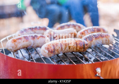 Close-up view of grilling sausages on barbecue grill outdoors