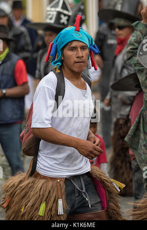 June 29, 2017 Cotacachi, Ecuador: indigenous kichwa man dancing in the street during Inti Raymi street dances Stock Photo