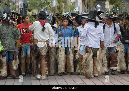 June 29, 2017 Cotacachi, Ecuador: indigenous kichwa men with extra large sombreros and leather chaps at Inti Raymi celebration Stock Photo