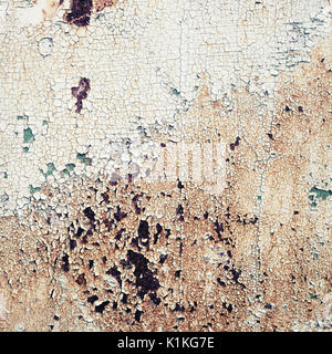Old peeling paint texture with cracks and rust spots. Grunge background. Stock Photo