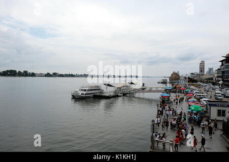 Dandong, Liaoning province, China – July 31, 2017: Waterfront of downtown Dandong on the Yalu river opposite Sinuiju, North Korea. Stock Photo