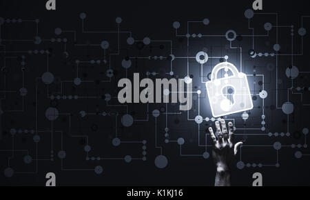 Lock glowing icon pressed with finger on dark background Stock Photo