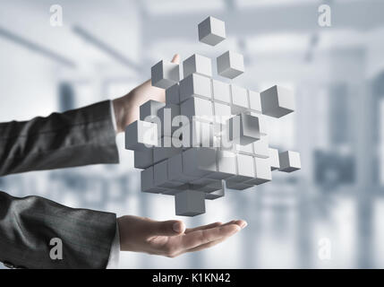 Cropped image of businessman hands holding multiple white cubes in hands. Mixed media. Stock Photo
