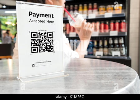 Qr code payment , online shopping , cashless technology concept. Coffee shop accepted digital pay without money , plastic tag on table. Stock Photo