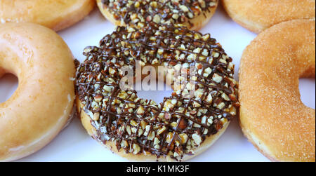 Chocolate with Chopped Almond Donuts with Sugar-glazed and Cinnamon-sugar Donuts on White Background Stock Photo