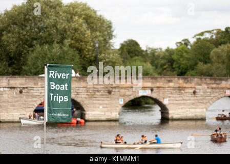 The river boat trips flag sign with boaters in the back ground around the Banbury road bridge, Stratford on Avon, Warwickshire. Stock Photo