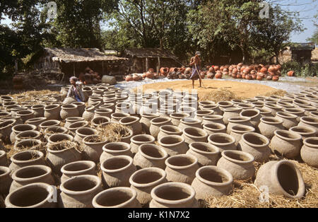 Clay pots and rice drying in sun, Burma (Myanmar) Stock Photo