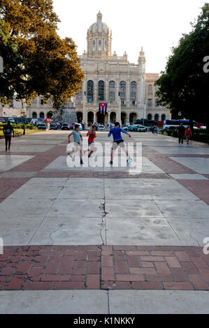 Boys playing soccer in front of the Presidential Palace in Havana Cuba Stock Photo