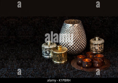 Gold and Silver Arabic Jar, vase and Candle holders Decorations on black carpet muslim celebration empty space for text to typing Stock Photo