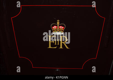 Queen Elizabeth sign crown on car monarch death died sign gold royal royalty side view vision classy embossed wood dark black picture wall buried Stock Photo