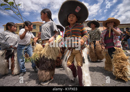 July 24, 2017 Cotacachi, Ecuador: indigenous kichwa children wearing chaps  on the street at Inti Raymi celebration Stock Photo