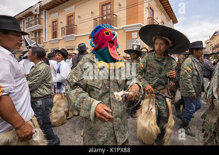 July 24, 2017 Cotacachi, Ecuador: indigenous kichwa men wearing a traditional mask  on the street at Inti Raymi celebration Stock Photo