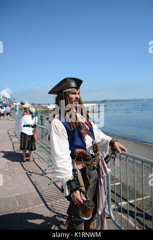 Penzance, Cornwall, UK. 27th August 2017. Pirates gather on the seafront at Penzance in an attempt to break the Guiness world record for the greatest number of pirates in place.  In 2014 Penzance narrowly failed to regain the title from Hastings, as they were 77 pirates short – most of whom were drinking outside the seafront pubs – and hence outside of the official counting zone.  They need 15000 pirates to win the event this year.     Credit: Simon Maycock/Alamy Live News Stock Photo