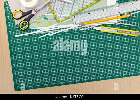 school and office supplies on green cutting mat board background, top view Stock Photo