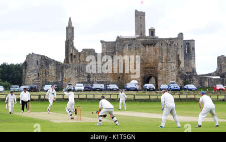 Embargoed to 0001 Monday August 28 A match at Warkworth Cricket Club on Saturday July 29, 2017, takes place at their home Castle Field, in the shadow of the Warkworth Castle. Stock Photo