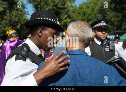 A policewoman has a word with Mayor of London, Sadiq Khan, at the Notting Hill carnival 2017.He spoke about the Grenfell fire tragedy Stock Photo