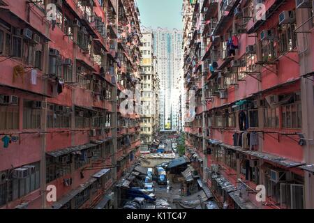Crowded government built public housing in old district of Hong Kong, China, with the contrast of luxury public condominium in the background, concept Stock Photo