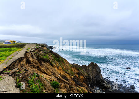 Waterfront campground nestled in the rugged coast of California showing washed out road and landslide Stock Photo