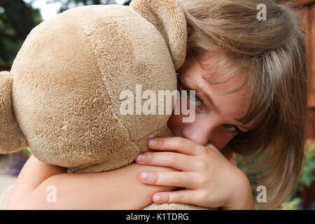 Portrait of little girl holding teddy bear Stock Photo