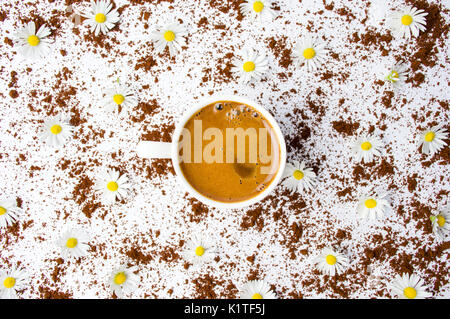 Cup of coffee with chamomile flowers on white, flat lay Stock Photo