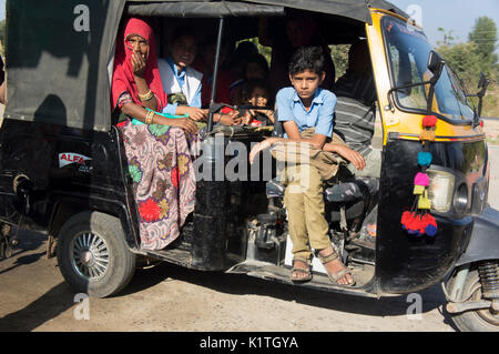 Mother and son   in auto rickshaw, also called tut-tut in India Stock Photo