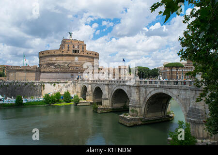 The historic building of Castel Sant'Angelo, former prison and Hadrian's Tomb, next to the Tiber River and bridge, on a summer day, Rome, Italy Stock Photo