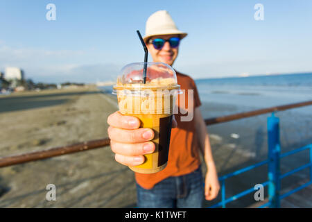 Young handsome man holding cup of take-out coffee. Stock Photo