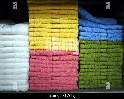 Photo of colorful towels stacked on a shelf Stock Photo