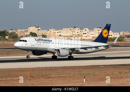 Lufthansa Airbus A320 passenger jet plane rotating nose up on the runway during takeoff. Modern civil aviation and air travel. Stock Photo