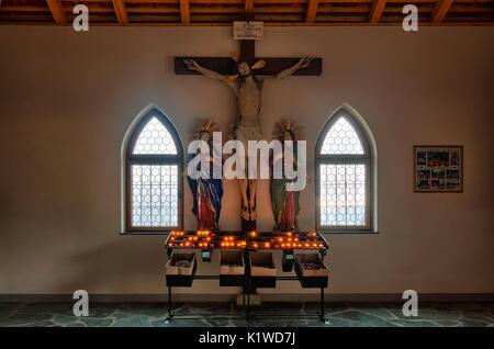 Religious symbols to the entrance of the Sanctuary of the Santa Croce in Val Badia, Dolomites, Italy Stock Photo