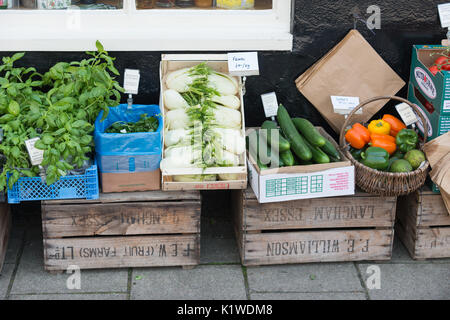 Boxes of fresh vegetables for sale outside a delicatessen in Arundel, West Sussex, England. Stock Photo