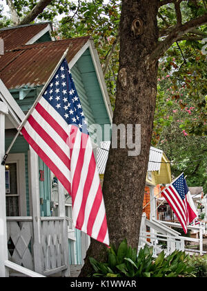 Spring TX USA - July 12, 2017  -  American Flag on Buildings in Old Town Spring TX with Trees and Plants Stock Photo