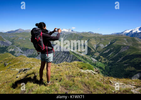 Woman taking a picture to the mountain with her mobile Stock Photo - Alamy