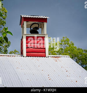 Spring, TX USA - July 12, 2017  -  Bell on a School Roof in Old Town Spring TX Stock Photo