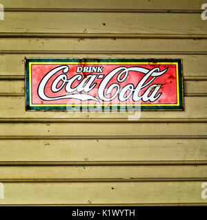 Spring TX USA - July 12, 2017  -  Old Drink Coca-Cola Steel Sign on Yellow Building in Old Town Spring TX Stock Photo