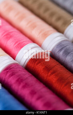 Sewing instruments, threads, needles, bobbins and materials. Studio photo Stock Photo