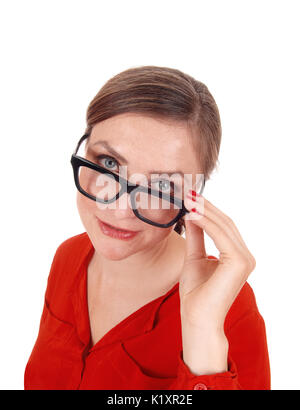 A young afraid looking woman with her hands on her glasses  standing isolated for white background Stock Photo
