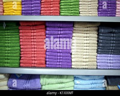 Photo of colorful towels stacked on a shelf Stock Photo