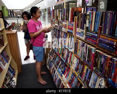 ANGONO, RIZAL, PHILIPPINES - AUGUST 26, 2017: Customers look at books on sale at a store in a shopping mall. Stock Photo