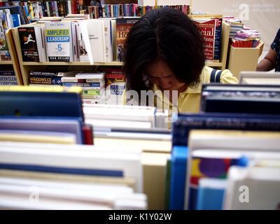 ANGONO, RIZAL, PHILIPPINES - AUGUST 26, 2017: Customers look at books on sale at a store in a shopping mall. Stock Photo