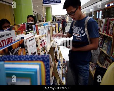 ANGONO, RIZAL, PHILIPPINES - AUGUST 26, 2017: Customers look at books on sale at a store in a shopping mall. Stock Photo