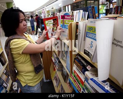 ANGONO, RIZAL, PHILIPPINES - AUGUST 26, 2017: Customers look at books on sale at a store in a shopping mall. Stock Photo