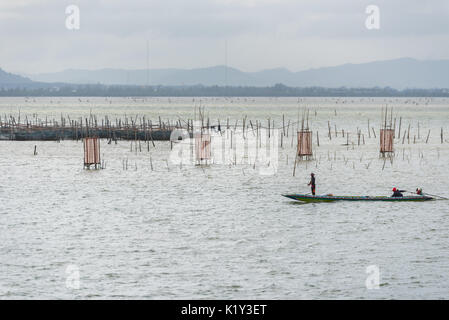 SONGKHLA THAILAND - FEBRUARY 18: Two fishermen in boat that surrounded by fish traps by local knowledge at Songkhla Lake on February 18, 2017 in Songk Stock Photo