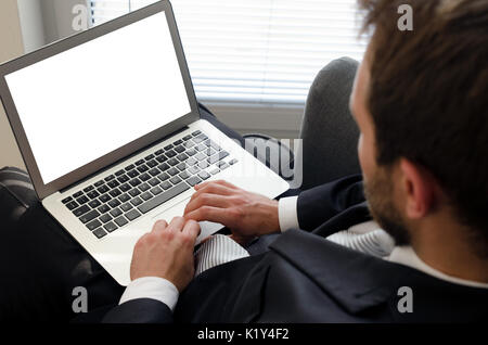 Businessman using laptop at home. Computer with blank empty screen Stock Photo