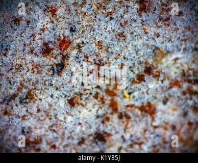 Background, macro. Thin layer of melting snow on stone. Spring closeup Stock Photo