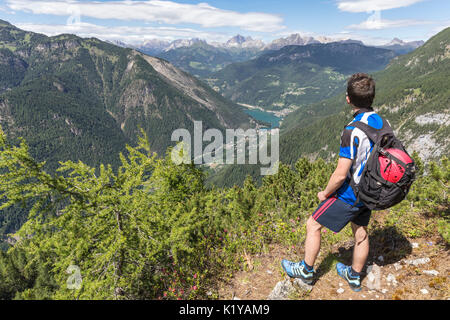 Europe, Italy, Veneto, San Tomaso Agordino, Dolomites, hiker looking Alleghe and the lake from the Col Mandro lookout Stock Photo