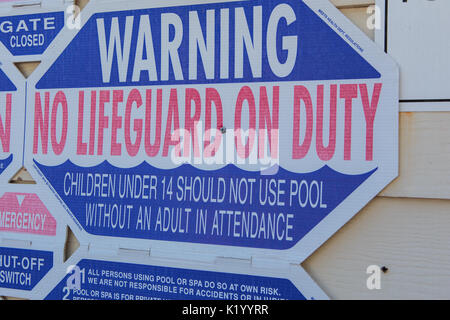 Swimming poolside warning, rules and safety signs and notices for swimmers using the pool Stock Photo